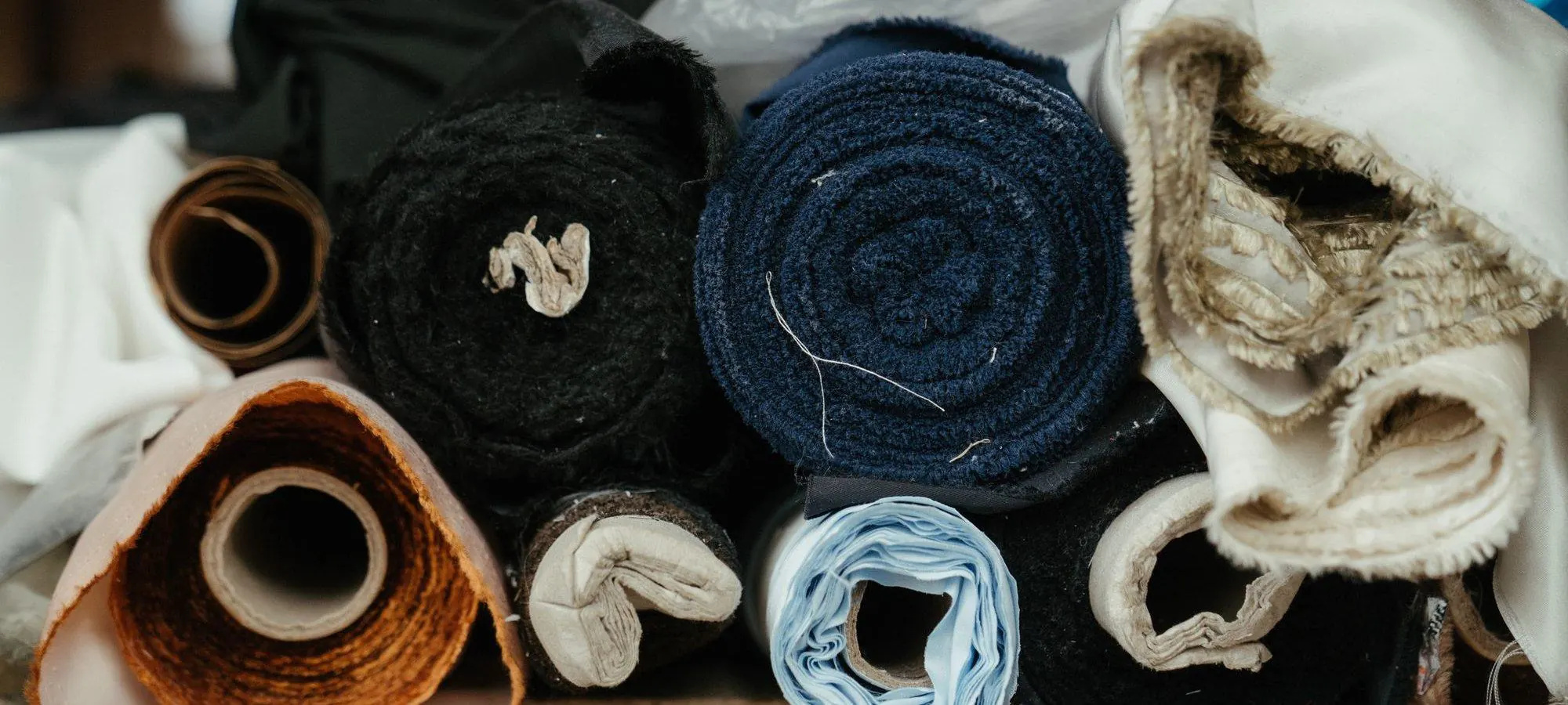Rolls of natural fabric in a workshop